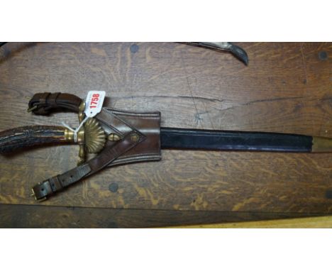 A good late 19th/early 20th century Continental short sword and leather scabbard, with antler handle and finely etched blade,