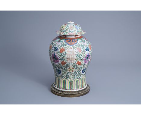 Title: A Chinese famille rose vase and cover mounted on a gilt bronze stand, 19th C.Description: H 44 cm