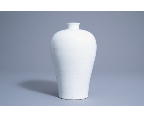 Title: A Chinese monochrome white glazed meiping vase with incised lotus scroll design, MingDescription: H 24,5 cm