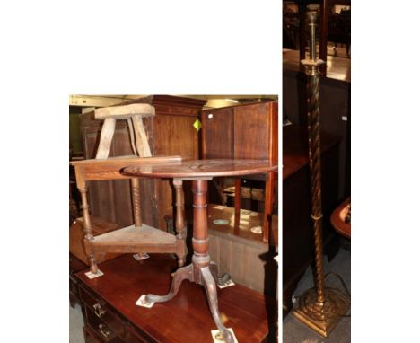 A George III mahogany tripod table; a 20th century oak corner table; a brass spiral turned standard lamp; and a rustic oak th