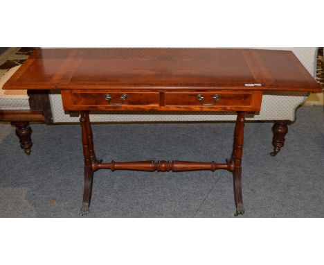 A reproduction yew wood and satinwood banded sofa table in the Regency style, 141cm long (extended)