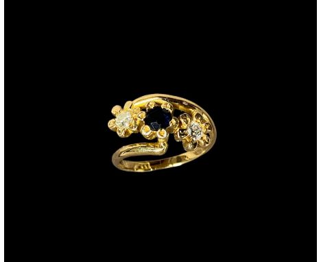 An 18ct gold ladies ring set with two diamonds and a larger central sapphire 6.6g size S