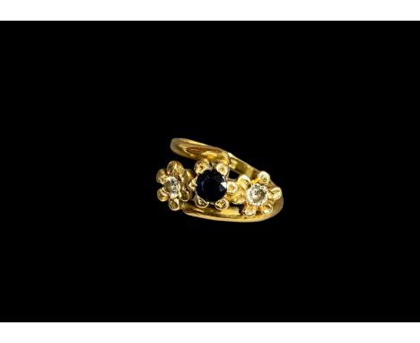 An 18ct gold ladies ring set with diamonds and a larger central sapphire size N   6.3grams
