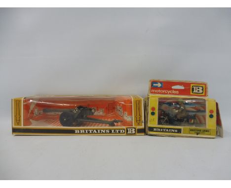 Two Britains boxed models: a 1/32 scale German field gun and a British Army Despatch Rider. 