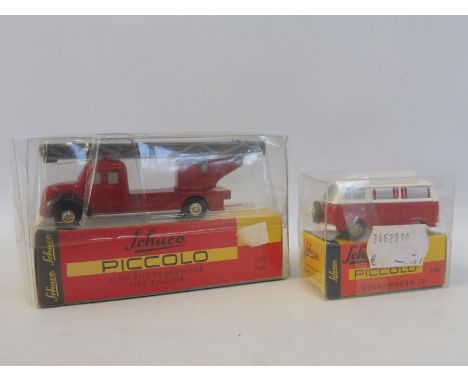 A boxed Schuco Piccolo VW camper and Magirus fire engine.