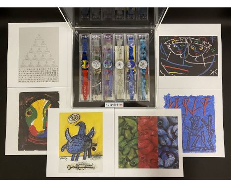 A collection of six Swatch Quartz watches, all unworn in original perspex cases within a perspex presentation box along with 