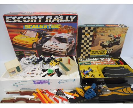 A box of various eras Scalextric cars, accessories and track. 