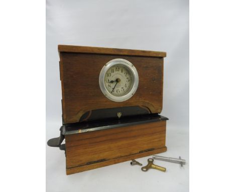 A National Time Recorder Co. Ltd clocking in and clocking out machine of small size with keys, by repute still working.