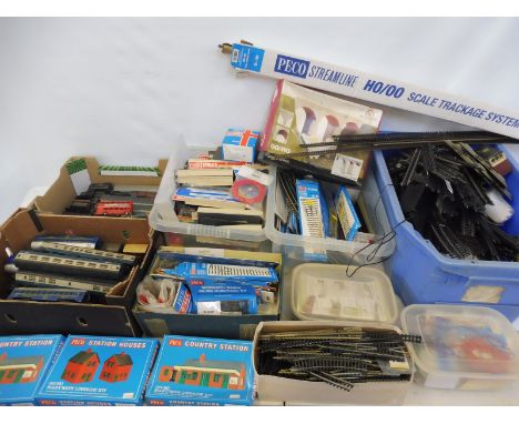 Four boxes of HO/OO scale track, railway and accessories, mainly Peco. 
