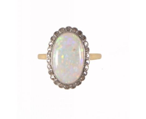 AN OPAL AND DIAMOND CLUSTER RING in gold, size P ++In satisfactory second hand condition, ring shank slightly distorted from 