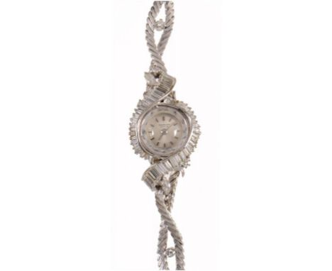 A DIAMOND COCKTAIL WATCH the bezel enveloped by a ribbon of baguette cut diamonds, on diamond set white gold entwined bracele