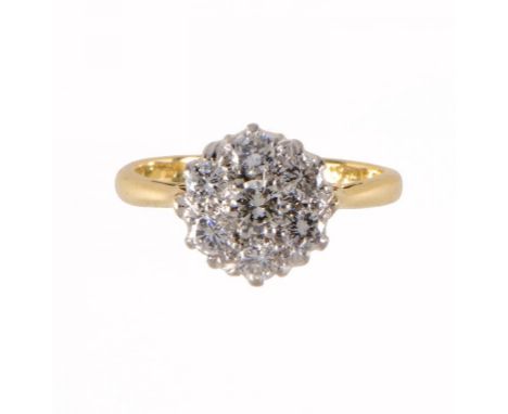 A DIAMOND CLUSTER RING with seven round brilliant cut diamonds in gold, foreign control mark, size H ++In good second hand co