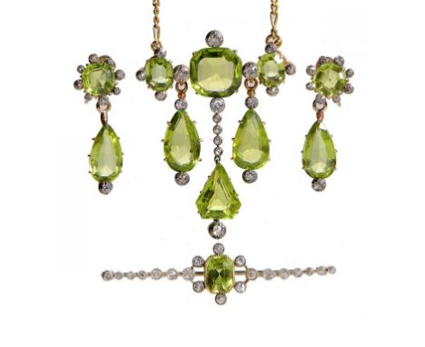 A FINE PERIDOT AND DIAMOND SUITE, C1920  of brooch-pendant, earrings and bar brooch, mounted in gold, fitted case of Carringt