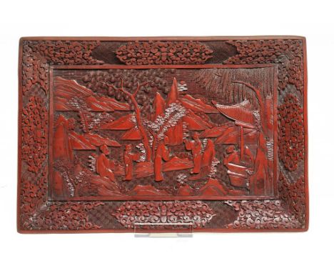 A CHINESE CINNABAR LACQUER TRAY, 19TH/EARLY 20TH C carved with a group of six figures and trees, on four low bracket feet, 25