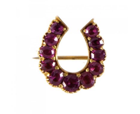 A VICTORIAN RUBY HORSESHOE BROOCH, C1880 in gold ++Of fine quality and condition, height 20mm, the rubies estimated to weigh 