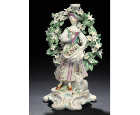 A DERBY CANDLESTICK FIGURE OF A SHEPHERDESS HOLDING A POSY OF FLOWERS, C1770  22cm h ++Typical chipping of the flowers, firin