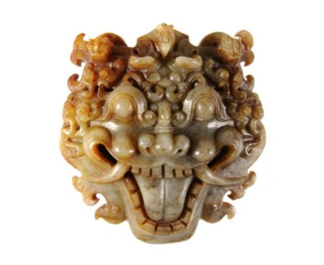 A CHINESE CELADON AND RUSSET JADE DRAGON MASK, 20TH C  8cm h ++In fine condition