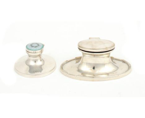 A GEORGE V SILVER AND ENAMEL CAPSTAN INKWELL 8cm diam, by Albert Carter, Birmingham 1920 and another, oval, Birmingham 1921, 