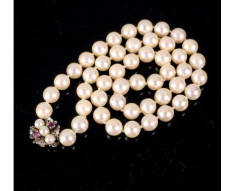 A CULTURED PEARL NECKLACE of a strand of 48 cultured pearls of approximately 8mm diameter, with ruby and cultured pearl set 1