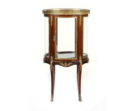 A FRENCH GILT BRASS MOUNTED MAHOGANY VITRINE, C1930 of oval section with bevelled glass inset top, 102cm h; 38 x 55cm ++Sever