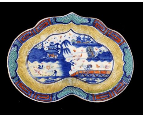 AN INTERESTING CAUGHLEY BLUE AND WHITE DESSERT DISH, C1785-93 THE ENAMEL DECORATION ADDED LATER in the Weir pattern, 27cm w, 