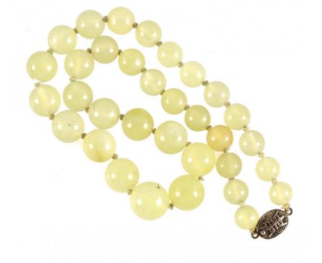 A CHINESE NECKLACE OF JADE BEADS, EARLY 20TH C  with silver clasp, beads 9.5-15.6mm diam, clasp marked in Chinese ++In good c