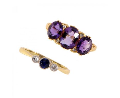 A SAPPHIRE AND DIAMOND THREE STONE RING in gold, marked 18ct & PT and an amethyst and diamond ring in gold, marked 18ct, size