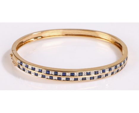 Gold bangle set with two bands of alternating sapphires and diamonds, 63mm wide