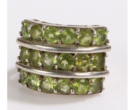 Substantial silver ring set with eighteen green stones, ring size M, 20.7g