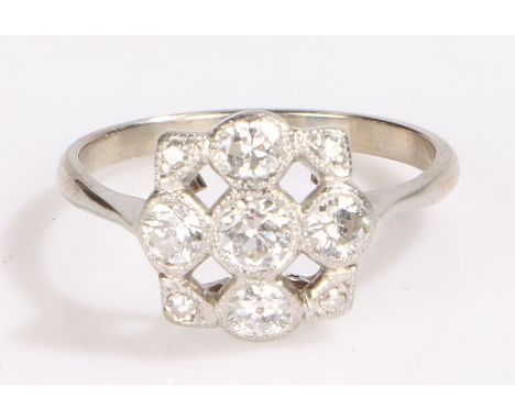 Diamond ring, the head set with a cross of five diamonds and with a diamond to each corner, estimated 0.70ct total, ring size