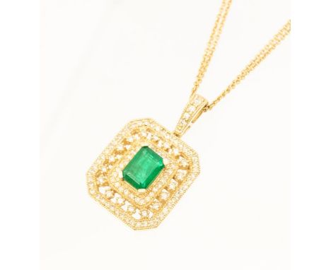 An emerald and diamond 14ct gold pendant, comprising an emerald cut emerald claw set to the centre, within a grain set border