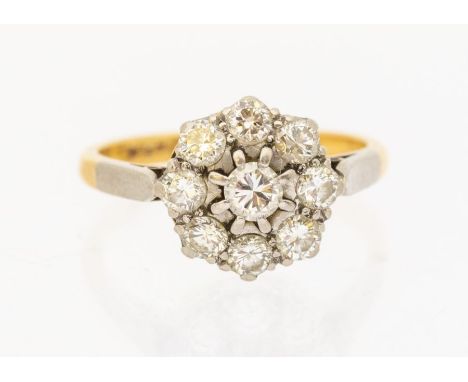 A diamond and 18ct gold cluster ring, comprising a central round brilliant cut diamond approx 0.21ct, claw set within a borde