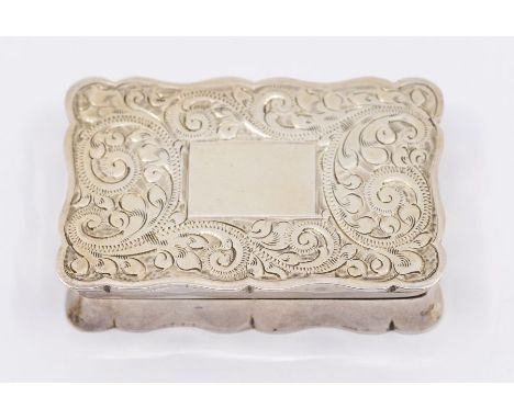A Georgian style silver cartouche shaped snuff box, profusely engraved with scrolling foliage, vacant cartouche, gilt interio