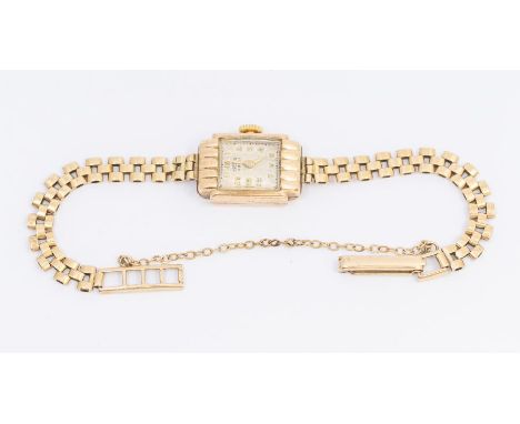 A ladies vintage Trebex 9ct gold wristwatch, comprising a rectangular Champaign dial with applied gilt Arabic markers, Art De