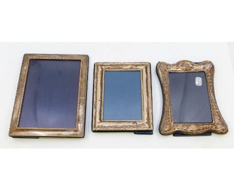 Three silver photo frames to include: a plain modern by Carrs of Sheffield, a smaller Modern profusely decorated frame by Car