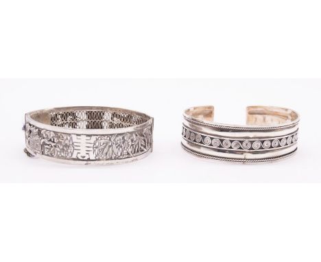 A Modern silver bangle with central Celtic swirl decoration, London import marks and an Asian white metal (untested silver) b