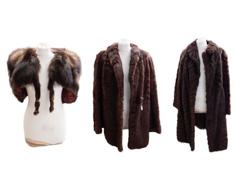 Two fur coats to include: one dark brown with a hint of henna, late 1940s, short to three-quarter length fur coat with covere
