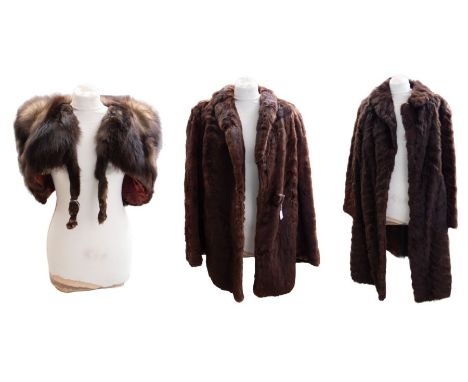 Two fur coats to include: one dark brown with a hint of henna, late 1940s, short to three-quarter length fur coat with covere