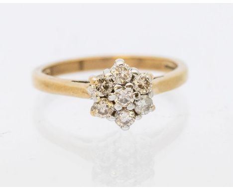 A diamond and 9ct gold cluster ring, comprising a floral arrangement of round brilliant cut diamonds, claw set in white gold,