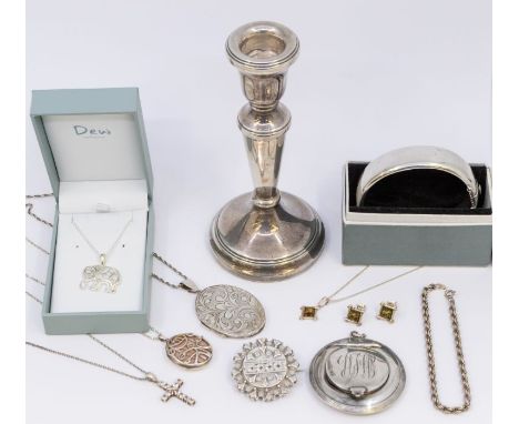 A collection of silver to include: a single modern weighted silver candlestick, Birmingham 2000, a Birmingham silver locket o