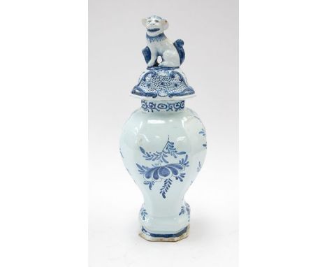 A 19th century Delft lidded vase in blue design of a gentleman playing a string instrument.