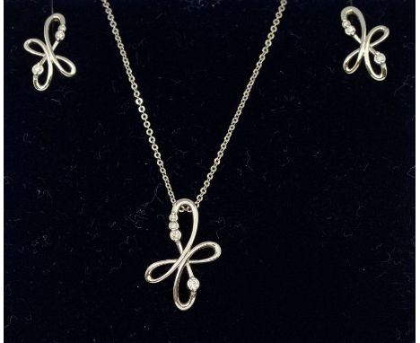 A diamond set 9ct white gold pendant and earrings set, comprising a floral wirework pendant set with small graduated round br