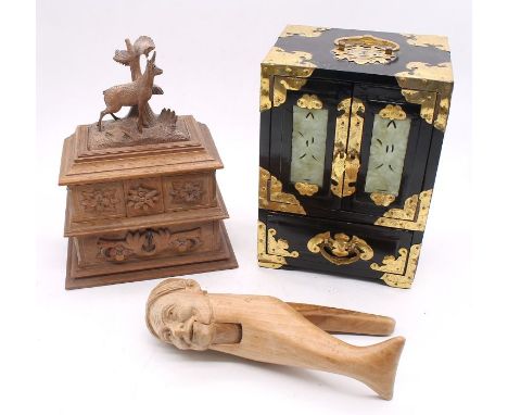 A carved black forest type jewellery casket with key, a modern Chinese lacquered box inset with jade type panels and along wi