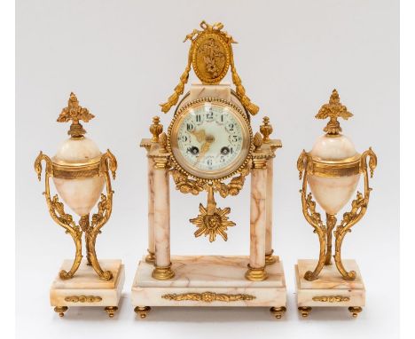 An early to mid 20th century ormolu style clock garniture consisting elaborate brass cased marble stone style column supports