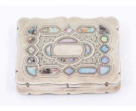 A George V opal inlaid silver cartouche shaped snuff box, engraved geometric sections to cover, hallmarked by S C Webb, Birmi