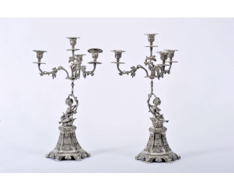 A pair of four-light candelabra, 833/1000 silver, decoration en relief "Putti", Portuguese, one unwelded, Oporto assay mark (