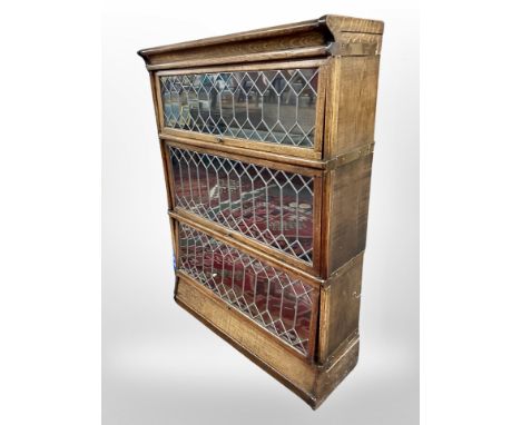 An Edwardian and oak leaded glass three tier stacking bookcase, in the style of Globe-Wernicke, 85 cm x 29 cm x 118 cm 