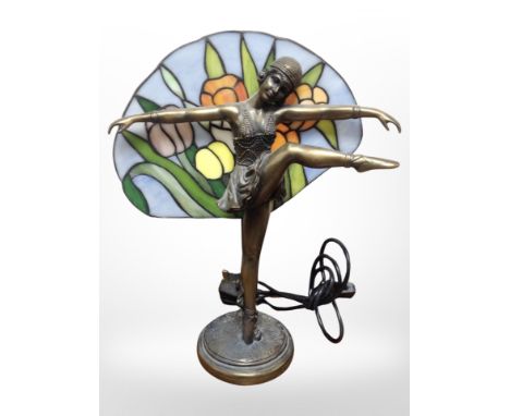 A contemporary Tiffany-style resin and glass table lamp modelled as a flapper girl, height 37cm.