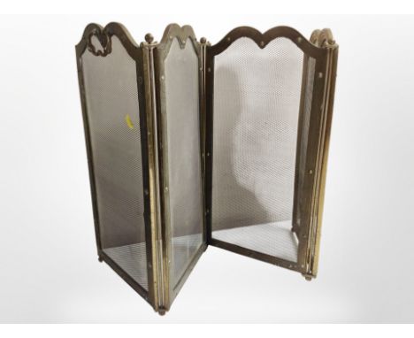 A Victorian brass four-fold fire screen, height 52cm.