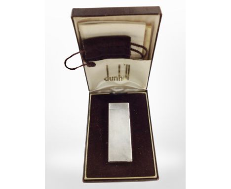 A Dunhill lighter in engine-turned case, boxed.